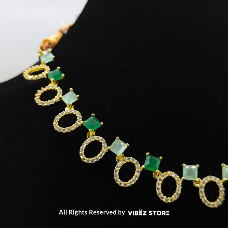 Gold-Plated Oval and Square Green Gemstone Necklace Set with Earrings 4 Gold-plated necklace set featuring oval and square green gemstones with matching drop earrings, elegantly displayed on a black mannequin.