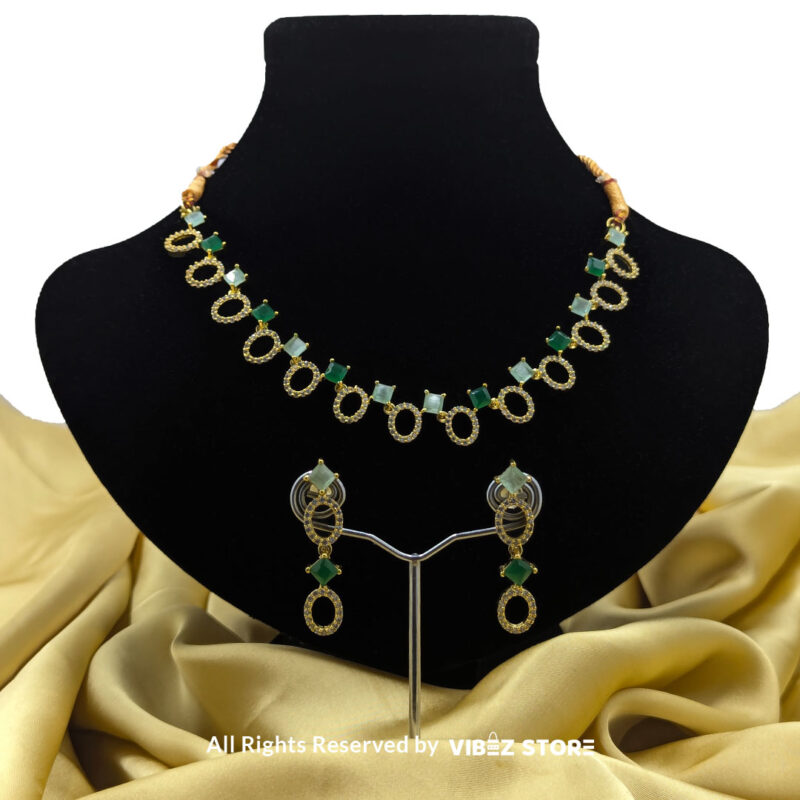 Gold-Plated Oval and Square Green Gemstone Necklace Set with Earrings 1 Gold-plated necklace set featuring oval and square green gemstones with matching drop earrings, elegantly displayed on a black mannequin.