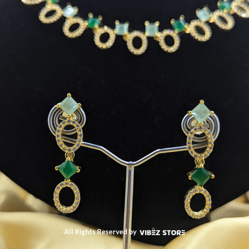 Gold-Plated Oval and Square Green Gemstone Necklace Set with Earrings 5 Gold-plated necklace set featuring oval and square green gemstones with matching drop earrings, elegantly displayed on a black mannequin.