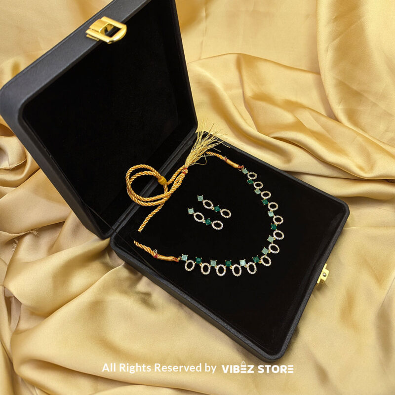 Gold-Plated Oval and Square Green Gemstone Necklace Set with Earrings 3 Gold-plated necklace set featuring oval and square green gemstones with matching drop earrings, elegantly displayed on a black mannequin.