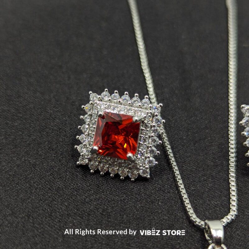 Ruby Red Square Pendant Jewelry Set 2 Ruby red square pendant jewelry set featuring a vibrant red gemstone necklace with matching stud earrings, surrounded by sparkling stones.