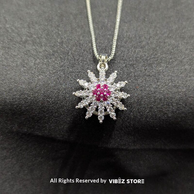 Ruby Bloom Sunflower Pendant and Earrings Set 1 Ruby sunflower jewelry set with a sparkling pendant and earrings featuring ruby-colored accents on a sleek black backdrop.