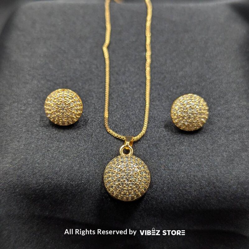 Sparkle Sphere Pendant and Earrings Set (Available in Multiple Colors) 3 Sphere-shaped pendant and earrings set featuring shimmering crystals, displayed on a sleek black backdrop. Available in multiple color variations.