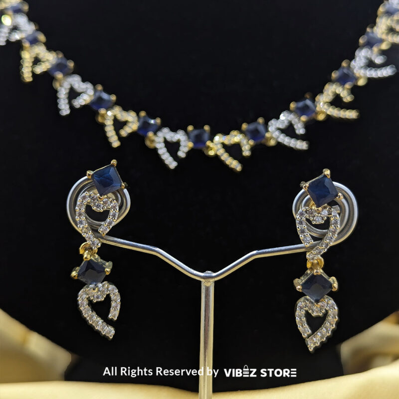 Heart & Sapphire Necklace & Earring Set Gold-Tone Crystal Jewelry 5 Heart & Sapphire Necklace and Earring Set with gold-tone settings, faux sapphire stones, and crystal heart motifs from VibezStore