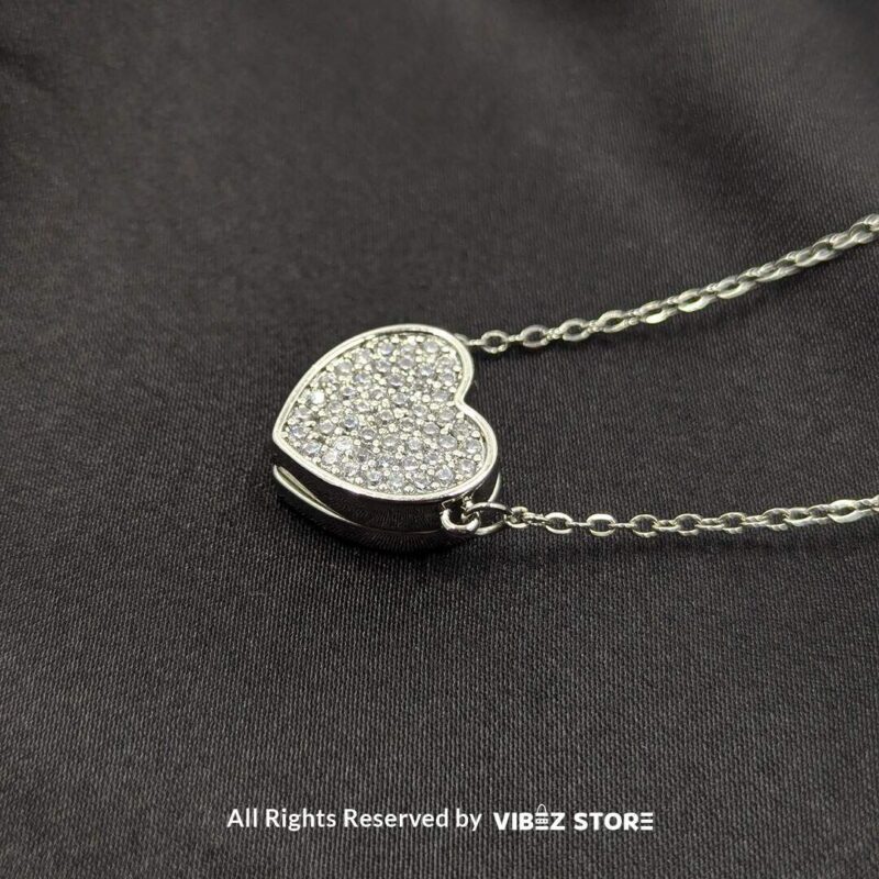 Magnetic Silver Heart Locket Necklace with Rhinestone Accents 1 Close-up of a magnetic silver heart locket necklace with rhinestone accents and a secure magnetic clasp.