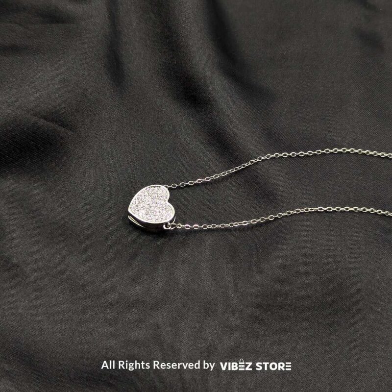 Magnetic Silver Heart Locket Necklace with Rhinestone Accents 2 Close-up of a magnetic silver heart locket necklace with rhinestone accents and a secure magnetic clasp.