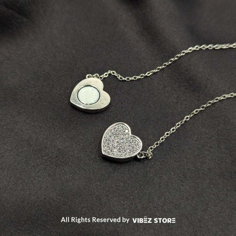 Magnetic Silver Heart Locket Necklace with Rhinestone Accents 3 Close-up of a magnetic silver heart locket necklace with rhinestone accents and a secure magnetic clasp.