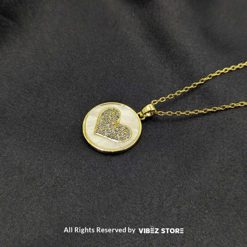 Golden Love Circle Locket with Heart Design 2 Golden circular locket featuring a sparkling heart design, perfect for gifting or adding elegance to any outfit.