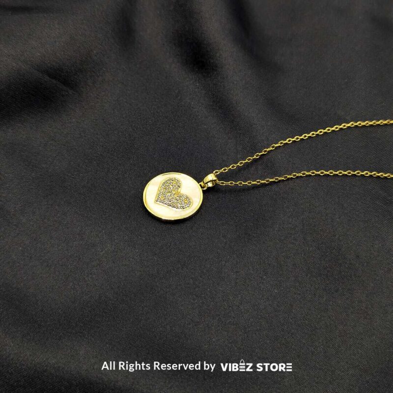 Golden Love Circle Locket with Heart Design 1 Golden circular locket featuring a sparkling heart design, perfect for gifting or adding elegance to any outfit.