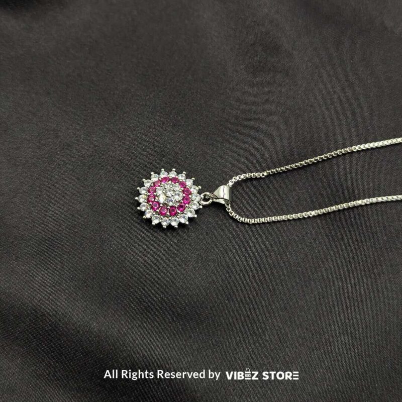 Multi-Color Gemstone Halo Lockets 4 A collection of three gemstone lockets in clear, gold-pink, and silver-pink tones, each surrounded by a dazzling crystal halo, displayed on a black fabric background.