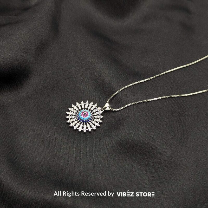 Radiant Starburst Lockets - Multi-Color Gemstone Collection 2 Three radiant starburst lockets in silver, gold, and silver-multi gemstone designs, featuring intricate crystal details, displayed on a sleek black fabric background.