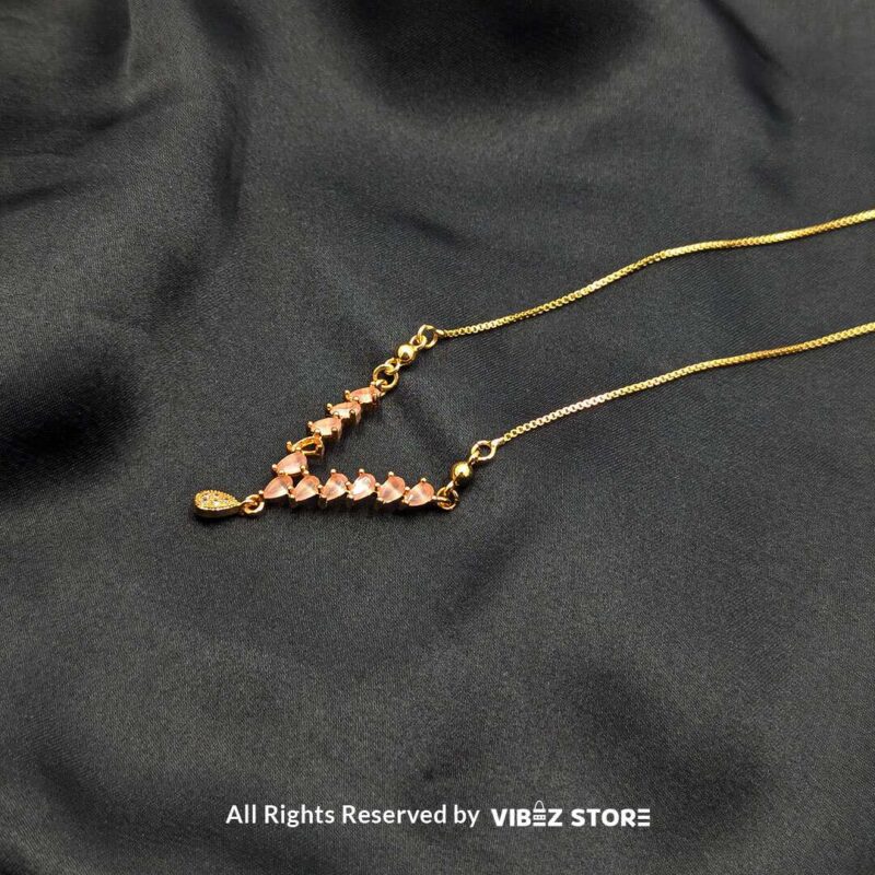 Heart Crystal V-Shaped Lockets - Sophisticated Jewelry 2 Three heart crystal V-shaped lockets in rose-gold, white-silver, and gold tones elegantly displayed on a black fabric background.