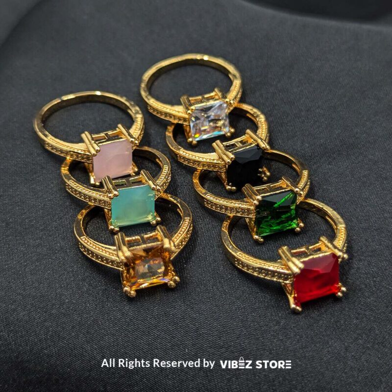 Luxurious Multi-Color Gemstone Rings (Gold-Tone) 1 Gold-tone non-adjustable rings with square gemstones in multiple colors, including rose pink, aqua blue, emerald green, ruby red, black, crystal white, and amber gold, beautifully displayed by Vibez Store.