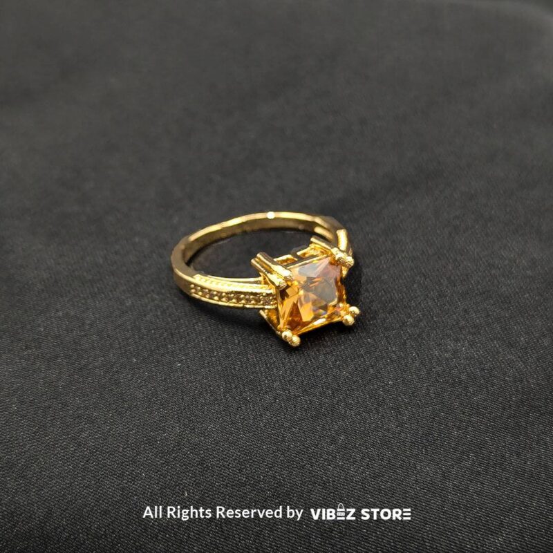 Luxurious Multi-Color Gemstone Rings (Gold-Tone) 7 Gold-tone non-adjustable rings with square gemstones in multiple colors, including rose pink, aqua blue, emerald green, ruby red, black, crystal white, and amber gold, beautifully displayed by Vibez Store.