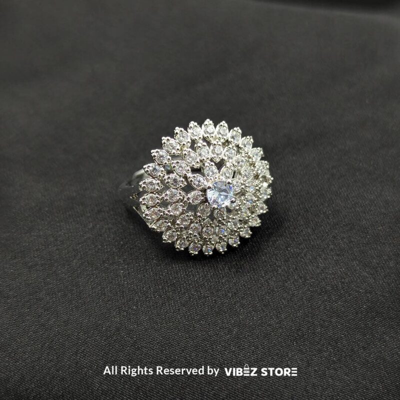 Dazzling Floral Crystal Rings 4 Silver-tone floral rings with crystal accents and central gemstones in sapphire blue, clear crystal, and jet black, beautifully displayed by Vibez Store.