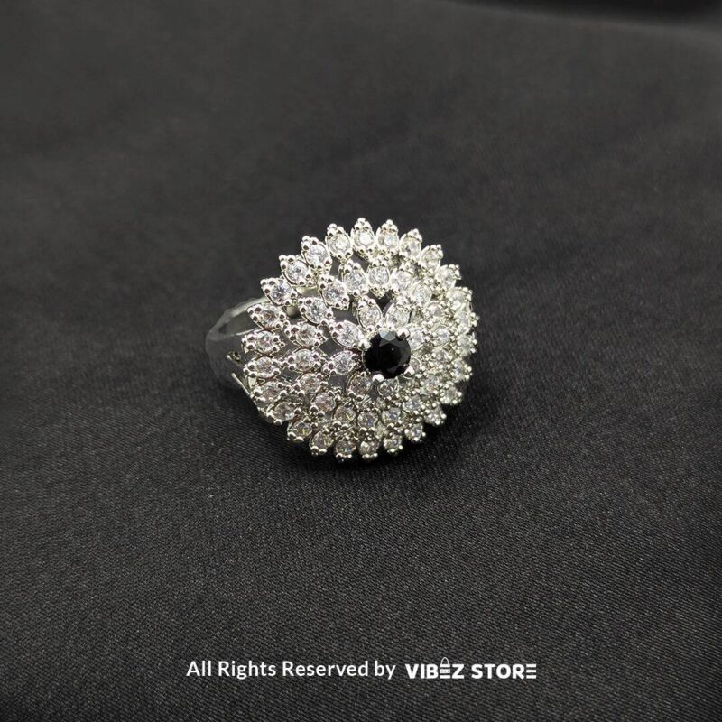 Dazzling Floral Crystal Rings 3 Silver-tone floral rings with crystal accents and central gemstones in sapphire blue, clear crystal, and jet black, beautifully displayed by Vibez Store.