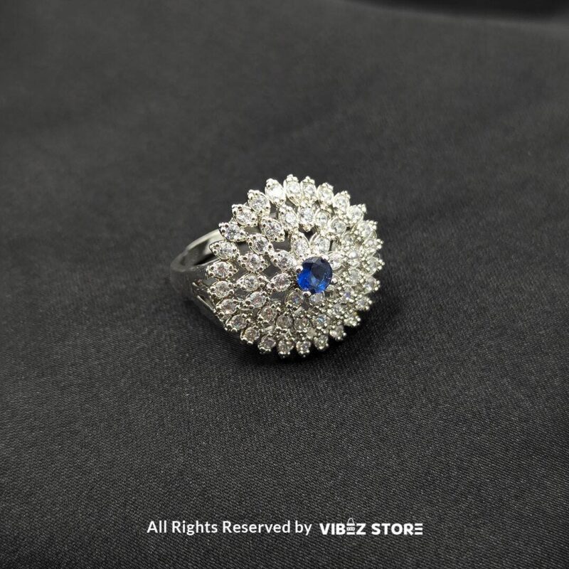 Dazzling Floral Crystal Rings 2 Silver-tone floral rings with crystal accents and central gemstones in sapphire blue, clear crystal, and jet black, beautifully displayed by Vibez Store.