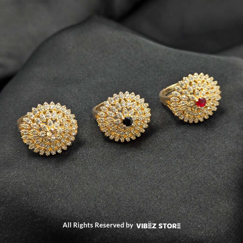 Radiant Floral Crystal Rings 1 Gold-tone floral rings with crystal accents and central gemstones in jet black, ruby red, and champagne gold, beautifully displayed by Vibez Store.