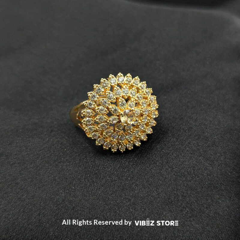 Radiant Floral Crystal Rings 3 Gold-tone floral rings with crystal accents and central gemstones in jet black, ruby red, and champagne gold, beautifully displayed by Vibez Store.