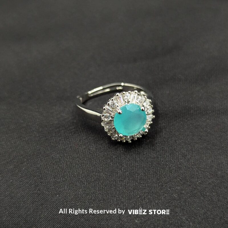 Elegant Halo Gemstone Adjustable Rings 4 Silver-tone halo rings with radiant gemstones in emerald green, rose pink, and aquamarine blue, encircled by sparkling crystals, showcased by Vibez Store.