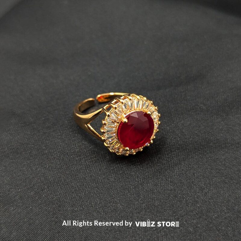 Ruby Radiance Adjustable Halo Ring Adjustable 3 A luxurious gold-tone ring with a ruby-red centerpiece encircled by a sparkling crystal halo, from Vibez Store.