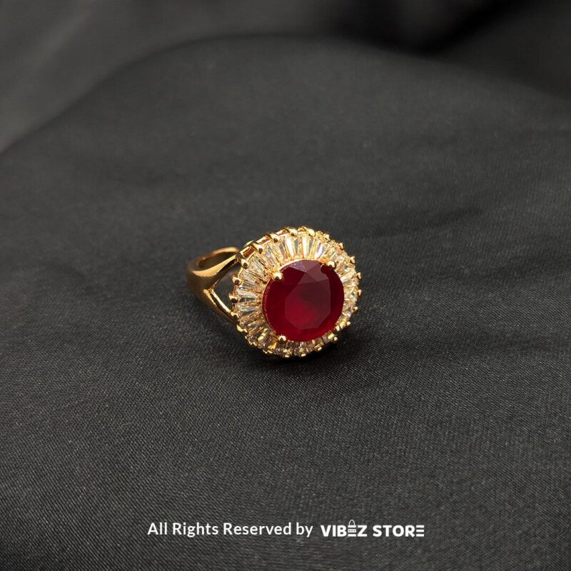 Ruby Radiance Adjustable Halo Ring Adjustable 2 A luxurious gold-tone ring with a ruby-red centerpiece encircled by a sparkling crystal halo, from Vibez Store.