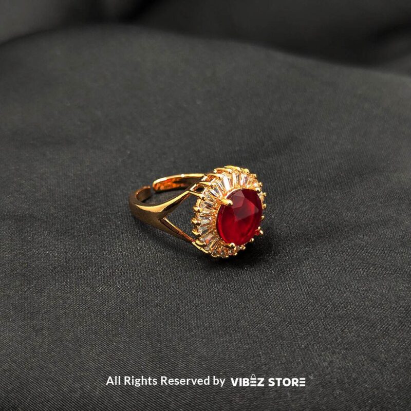 Ruby Radiance Adjustable Halo Ring Adjustable 1 A luxurious gold-tone ring with a ruby-red centerpiece encircled by a sparkling crystal halo, from Vibez Store.