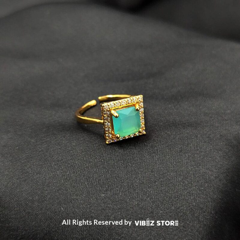 Elegant Square Gemstone Rings (Adjustable, Color Variations Available) 3 Gold-tone adjustable rings with square gemstones in rose pink, aqua blue, and sapphire variations, elegantly displayed by Vibez Store.