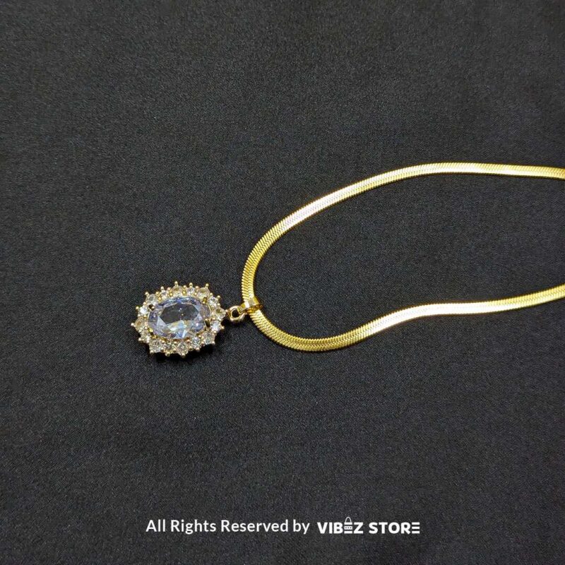 Gold Oval Pendant Necklace with Radiant Crystal 2 Gold Oval Pendant Necklace with a radiant crystal centerpiece and a sleek gold-tone chain – Vibez Store.