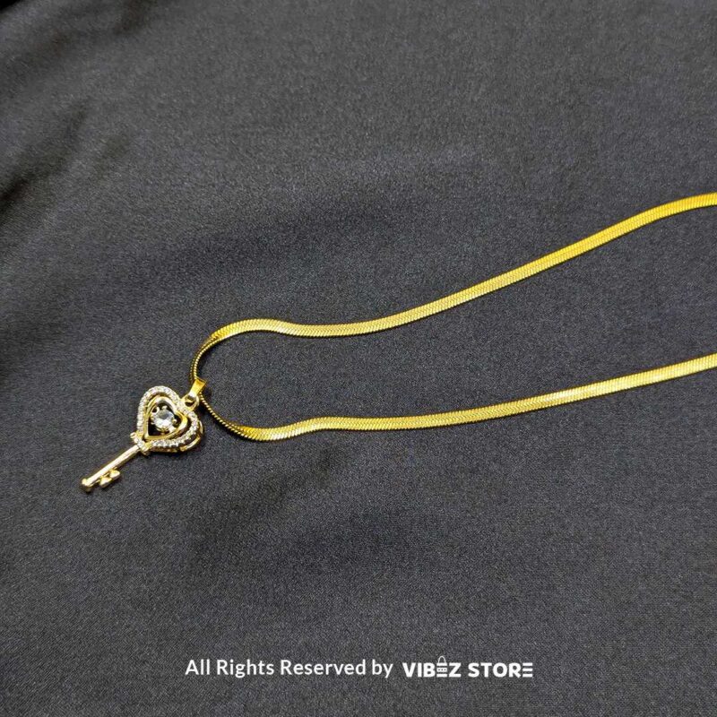 Gold Heart Key Pendant Necklace 2 Gold Heart Key Pendant Necklace with a sparkling crystal centerpiece on a sleek gold chain – Vibez Store.