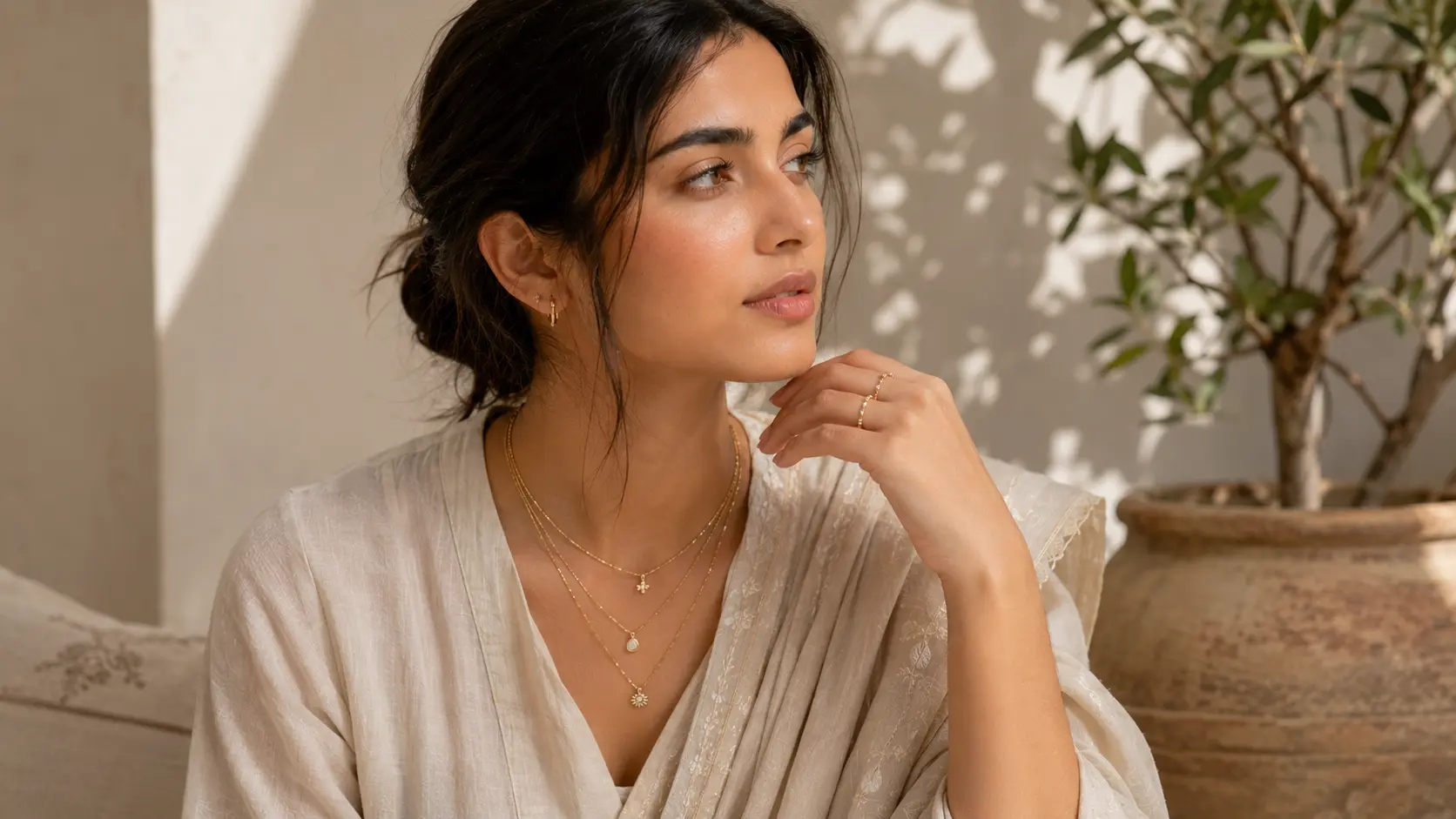 Minimal Jewellery Trends in Pakistan for Girls in 2026 3 Pakistani girl wearing layered delicate chain necklaces with minimalist fashion styling