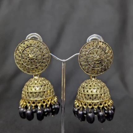 Pair of antique gold jhumka earrings with black bead drops and filigree pattern