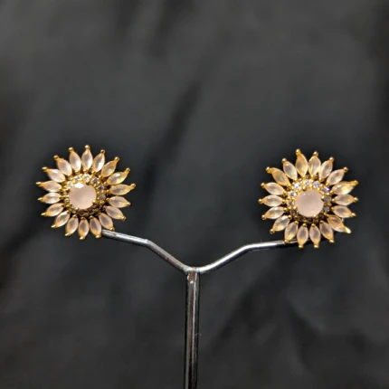 Blush pink gold floral stud earrings with petal style stones and sparkling detail