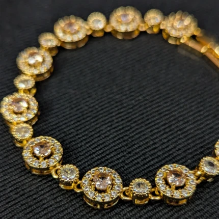 Gold bracelet with blush pink stones and clear crystal style halo detailing