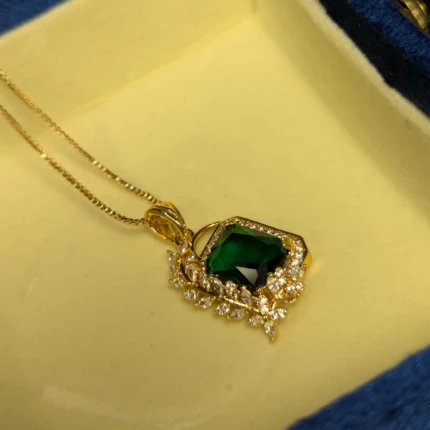 Gold green stone pendant necklace with crystal style leaf detail