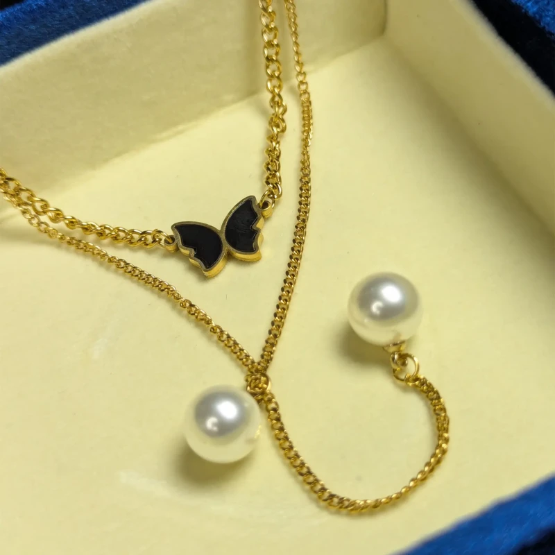 Gold Layered Butterfly Pearl Necklace for Women 2 Gold layered butterfly pearl necklace with black charm and pearl style beads
