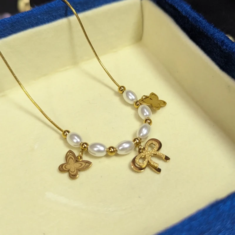 Gold Pearl Butterfly Charm Necklace for Women 2 Gold pearl butterfly charm necklace with bow charm and pearl style beads