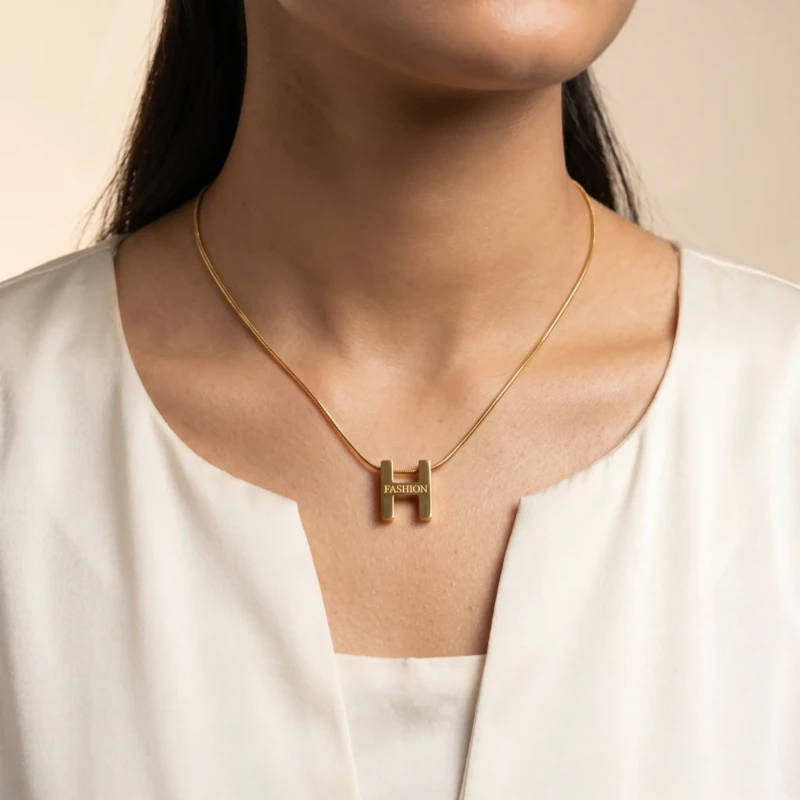 Gold H Fashion Pendant Necklace for Women 1 Model wearing gold H alphabet pendant necklace with white outfit