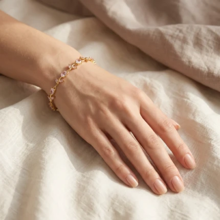 Model wearing pink stone gold vine bracelet on wrist