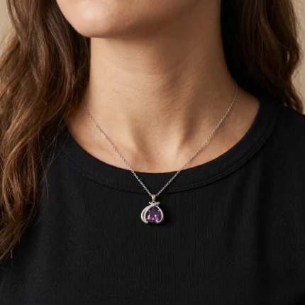 Model wearing purple heart silver pendant necklace with black outfit