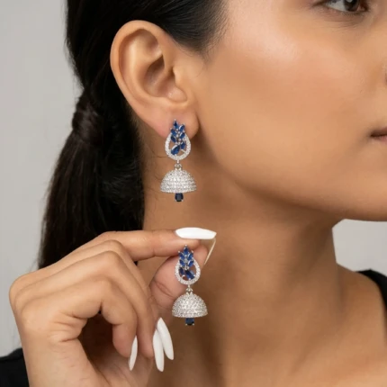 Model wearing royal blue silver jhumka earrings with formal look