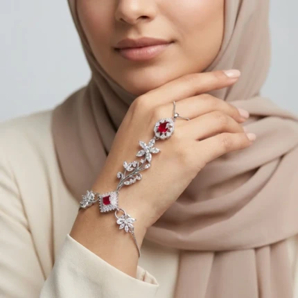 Model wearing ruby red silver hathphool bracelet on hand with elegant outfit