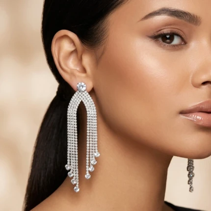 Model wearing silver crystal chandelier tassel earrings for formal party look