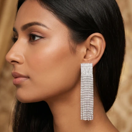 Model wearing silver crystal tassel earrings with formal evening look