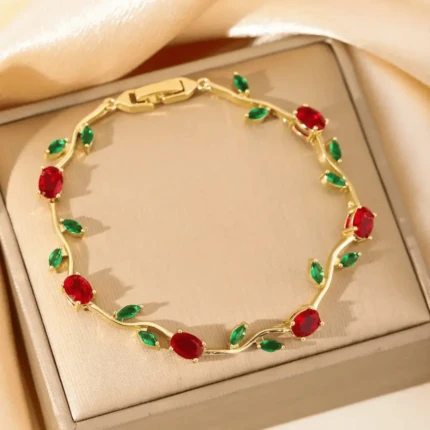 Red green gold vine bracelet with ruby red stones and emerald green leaf design