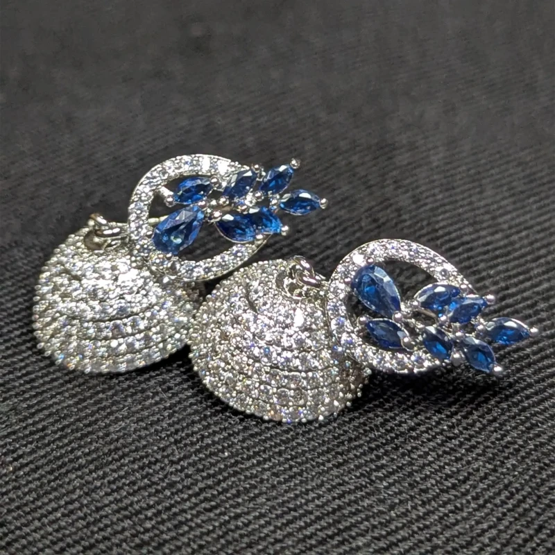 Royal Blue Silver Jhumka Earrings for Women 3 Silver jhumka earrings with royal blue leaf stones and sparkling crystal dome detail