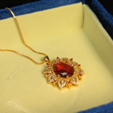Ruby red gold floral pendant necklace with sparkling crystal style stones