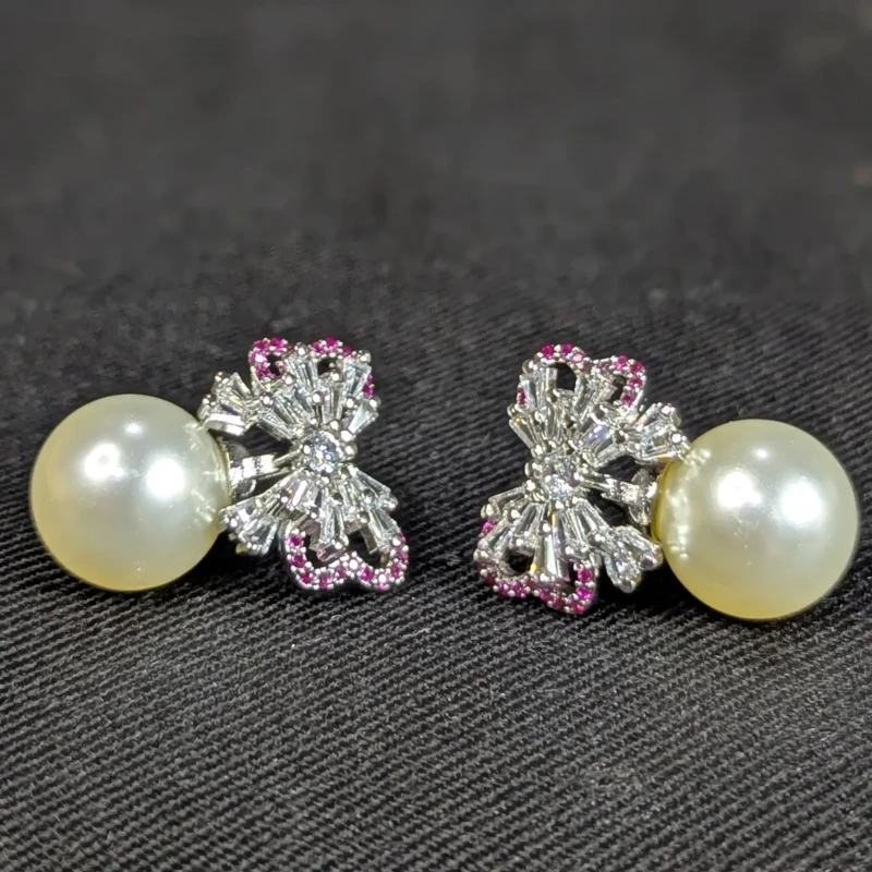 Silver Pearl Bow Earrings for Women 2 Silver bow pearl drop earrings with crystal style stones and pink detailing