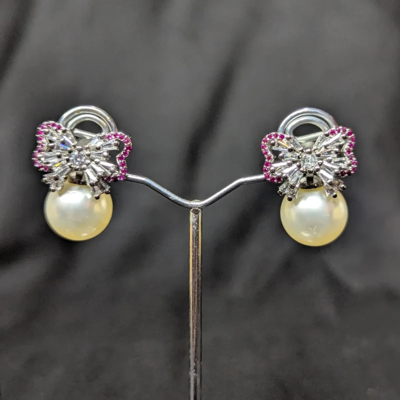 Silver Pearl Bow Earrings for Women 3 Silver pearl bow earrings with pink accent stones and pearl style drops