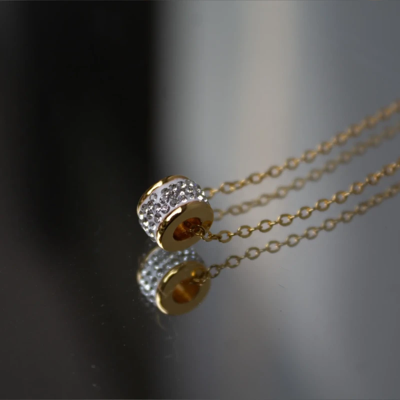 Gold-Tone Crystal Barrel Pendant Necklace for Women 2 Close-up of gold-tone barrel pendant with clear crystal detailing